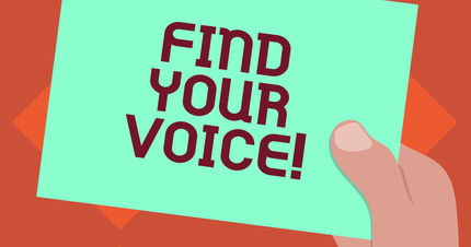hand holding card that reads find your voice
